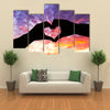 Silhouette hand in heart shape and beautiful sky multi panel canvas wall art