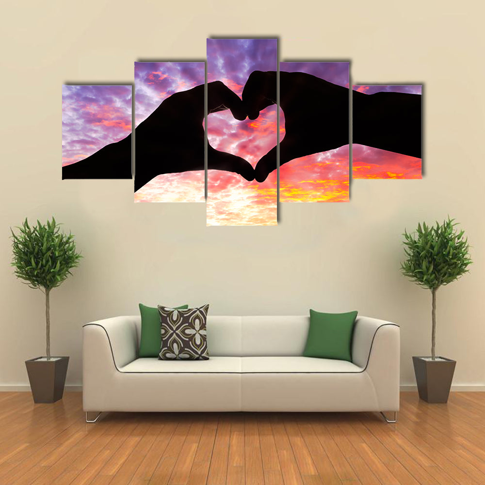 Silhouette hand in heart shape and beautiful sky multi panel canvas wall art