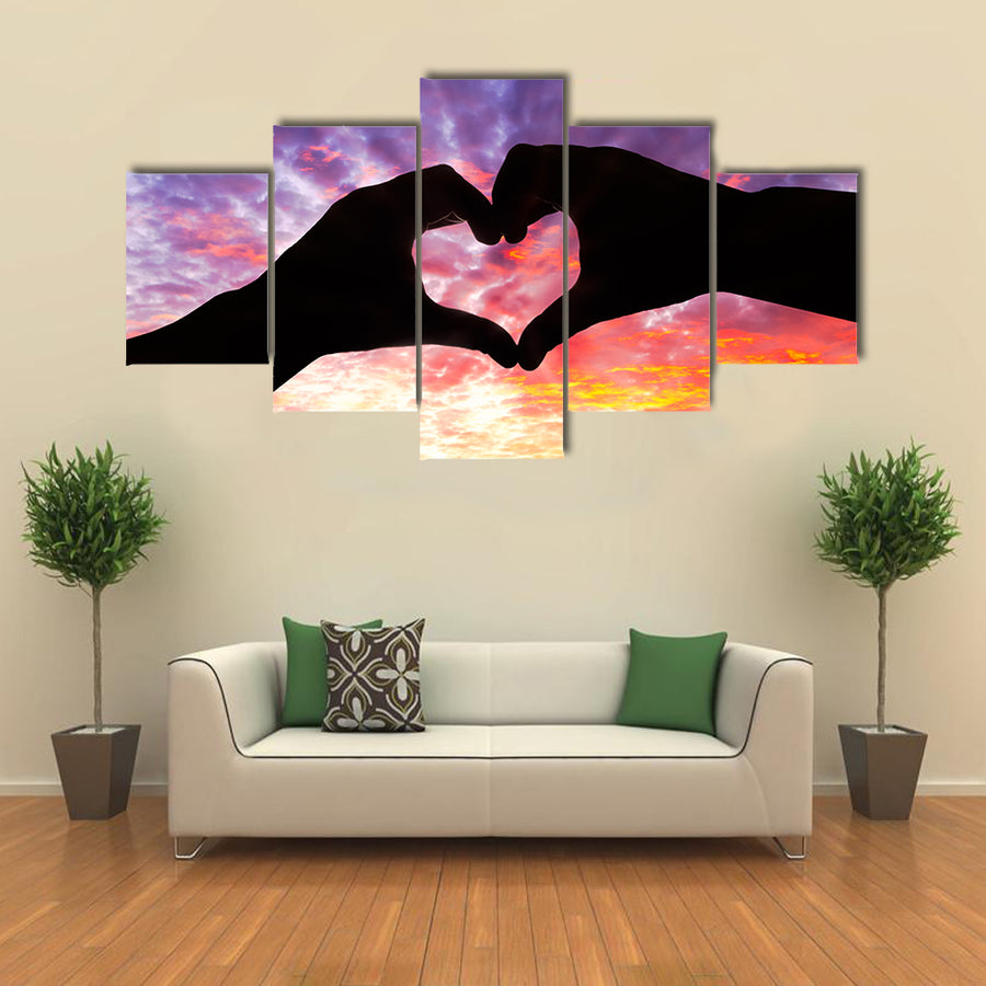 Silhouette hand in heart shape and beautiful sky multi panel canvas wall art