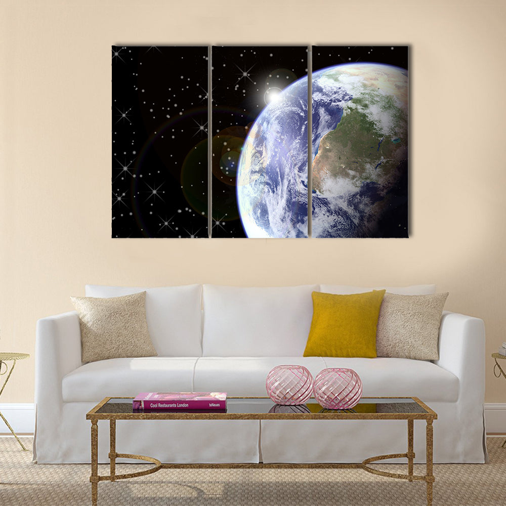 Sunrise from space. Sunburst behind the earth, generated in PS. Earth and stars seen clearly at 100% Multi Panel Canvas Wall Art