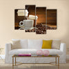 Cups of coffee with smoke and coffee beans on old wooden background Multi Panel Canvas Wall Art