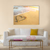 Heart drawn on the sand of a sea beach, soft wave and solar glare Multi panel canvas wall art