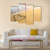 Heart drawn on the sand of a sea beach, soft wave and solar glare Multi panel canvas wall art