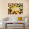 Uncooked pasta and spices on a dark wooden background Multi panel canvas wall art