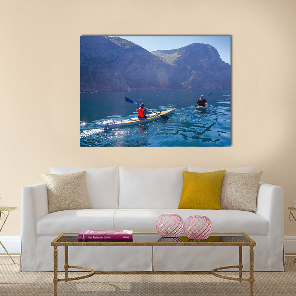 People kayaking in the sea near the mountains multi panel canvas wall art