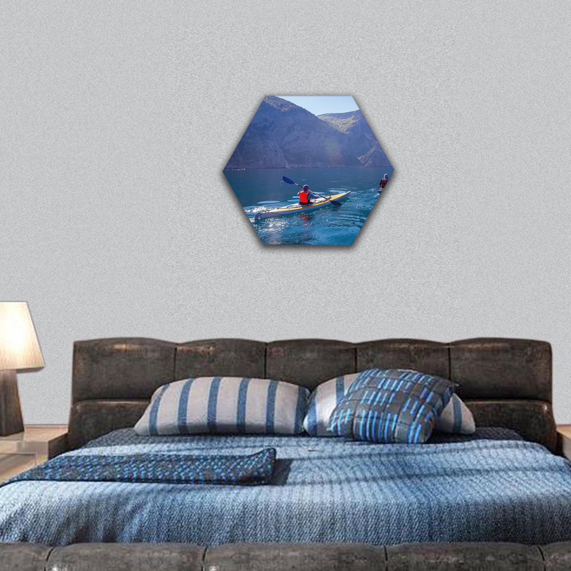 People kayaking in the sea near the mountains hexagonal canvas wall art