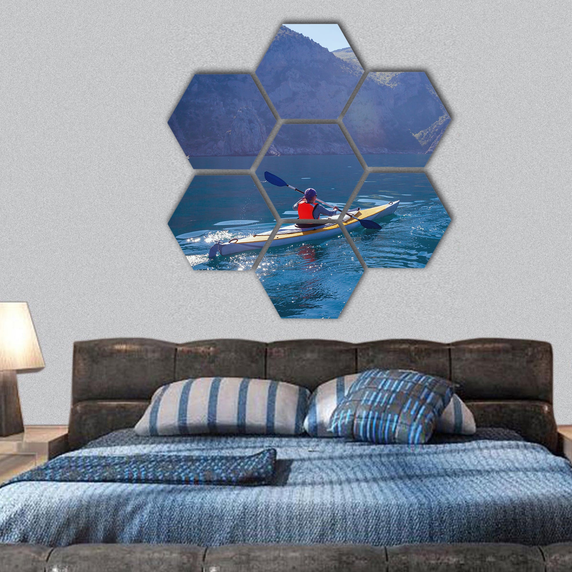 People kayaking in the sea near the mountains hexagonal canvas wall art