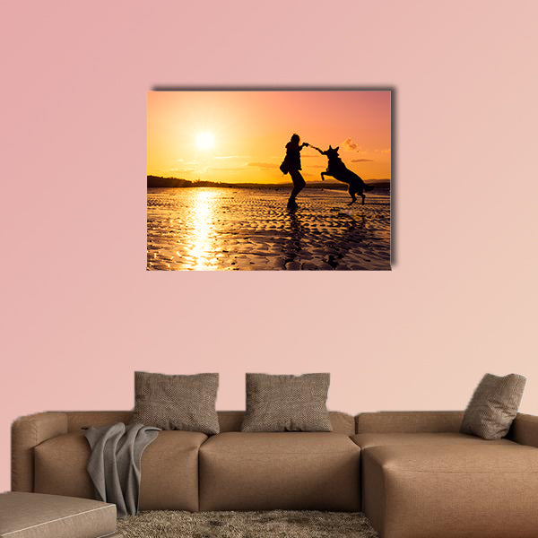Hipster girl playing with dog at a beach during sunset, wall art
