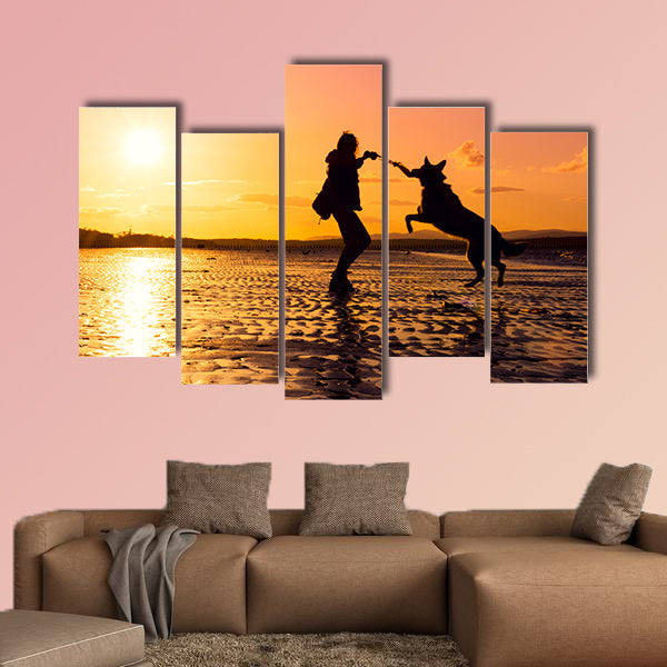 Hipster girl playing with dog at a beach during sunset, wall art