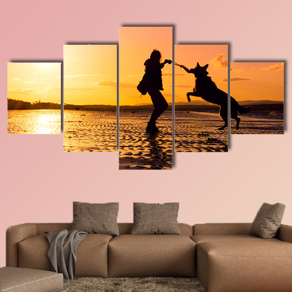 Hipster girl playing with dog at a beach during sunset, wall art