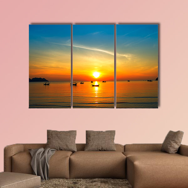 Silhouette of fisher man's boats on the tropical sea with colorful sunrise wall art