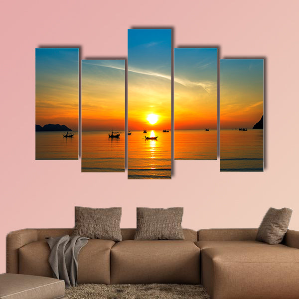 Silhouette of fisher man's boats on the tropical sea with colorful sunrise wall art