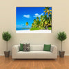 Amazing tropical beach with palm tree entering the ocean against Azur Ocean, gold sand and blue sky Multi panel canvas wall art