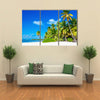 Amazing tropical beach with palm tree entering the ocean against Azur Ocean, gold sand and blue sky Multi panel canvas wall art