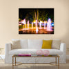 Small fountain in the city park on a summer night multi panel canvas wall art