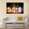 Small fountain in the city park on a summer night multi panel canvas wall art