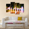 Small fountain in the city park on a summer night multi panel canvas wall art