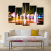 Small fountain in the city park on a summer night multi panel canvas wall art