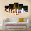 Small fountain in the city park on a summer night multi panel canvas wall art