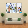 Woman and man having fun in volley ball game in summer Multi panel canvas wall art