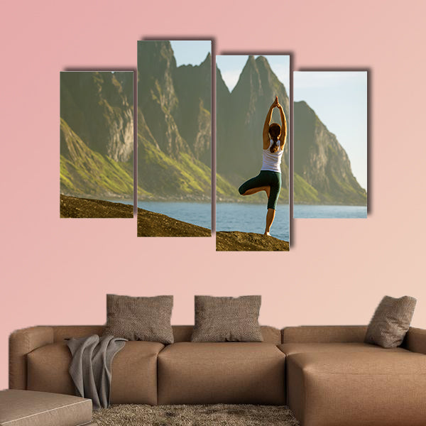 Young woman is practicing yoga between mountains in Norway multi panel canvas wall art