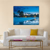 Tropical beach with palm trees and resort lights at night low tide multi panel canvas wall art