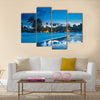 Tropical beach with palm trees and resort lights at night low tide multi panel canvas wall art