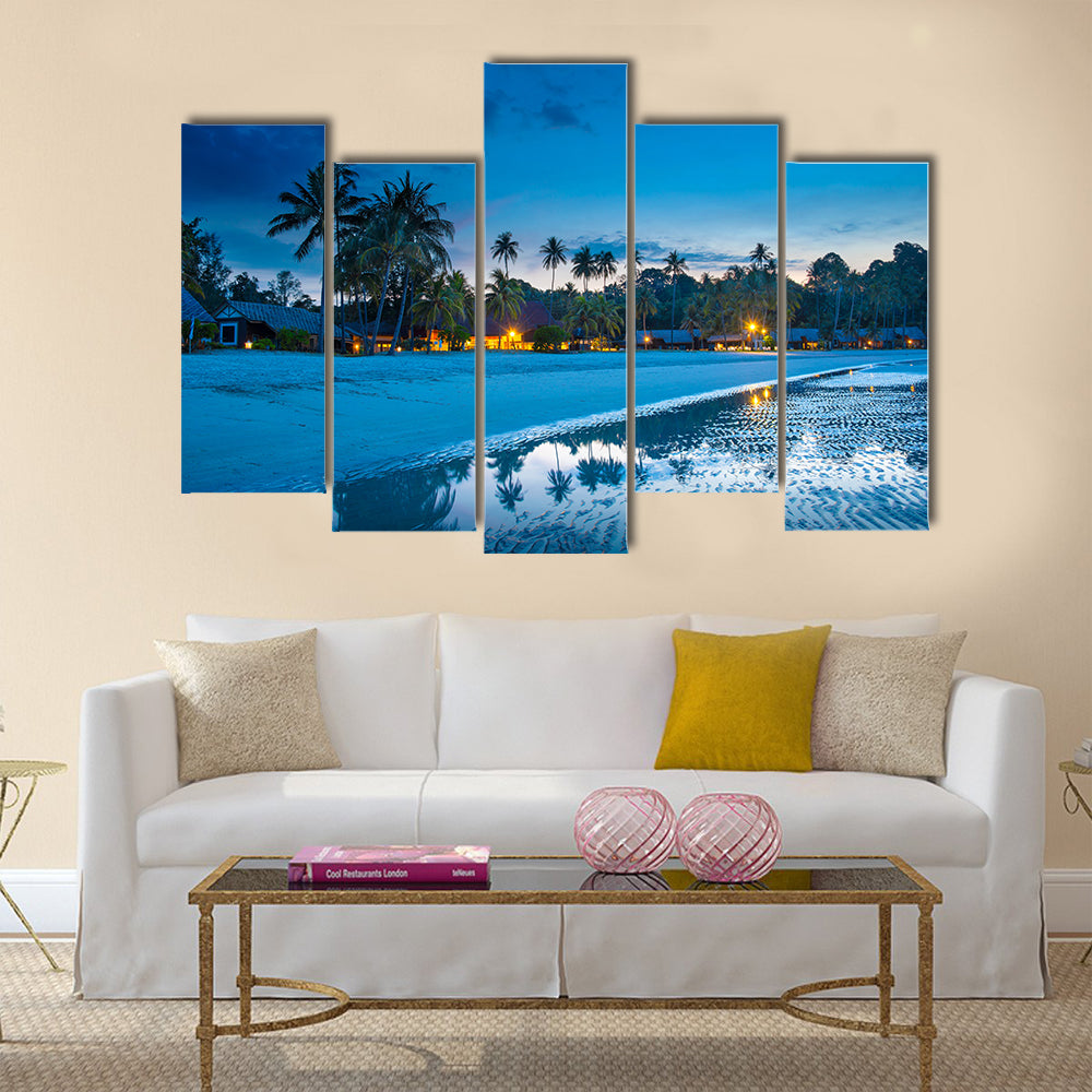 Tropical beach with palm trees and resort lights at night low tide multi panel canvas wall art