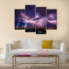 Lightning storm over city in purple light Multi Panel Canvas Wall Art