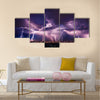 Lightning storm over city in purple light Multi Panel Canvas Wall Art