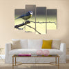 A Blue-Tit perched on a hawthorn branch on a winters day Multi panel canvas wall art