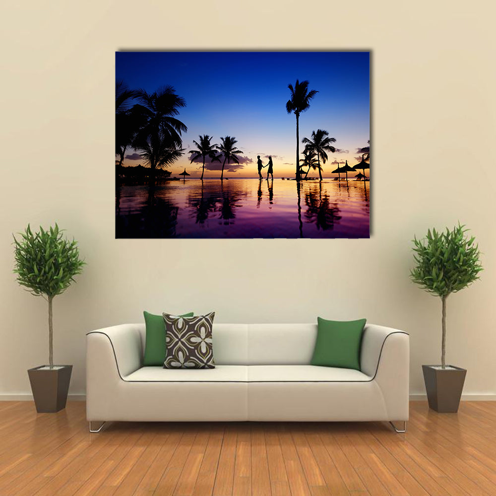 Silhouettes of young couple at scenic sunset on tropical beach multi panel canvas wall art