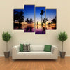 Silhouettes of young couple at scenic sunset on tropical beach multi panel canvas wall art