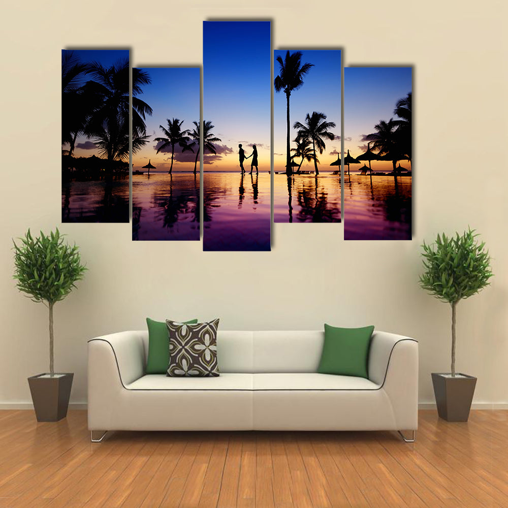 Silhouettes of young couple at scenic sunset on tropical beach multi panel canvas wall art