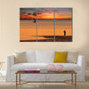 Beach sunset scene in Mozambique with fisherman and small sailboat Multi panel canvas wall art