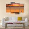 Beach sunset scene in Mozambique with fisherman and small sailboat Multi panel canvas wall art