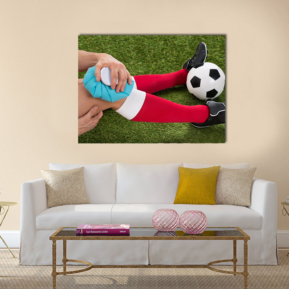 Close-up of a Soccer Player Icing Knee with Ice Pack on Field Multi panel canvas wall art