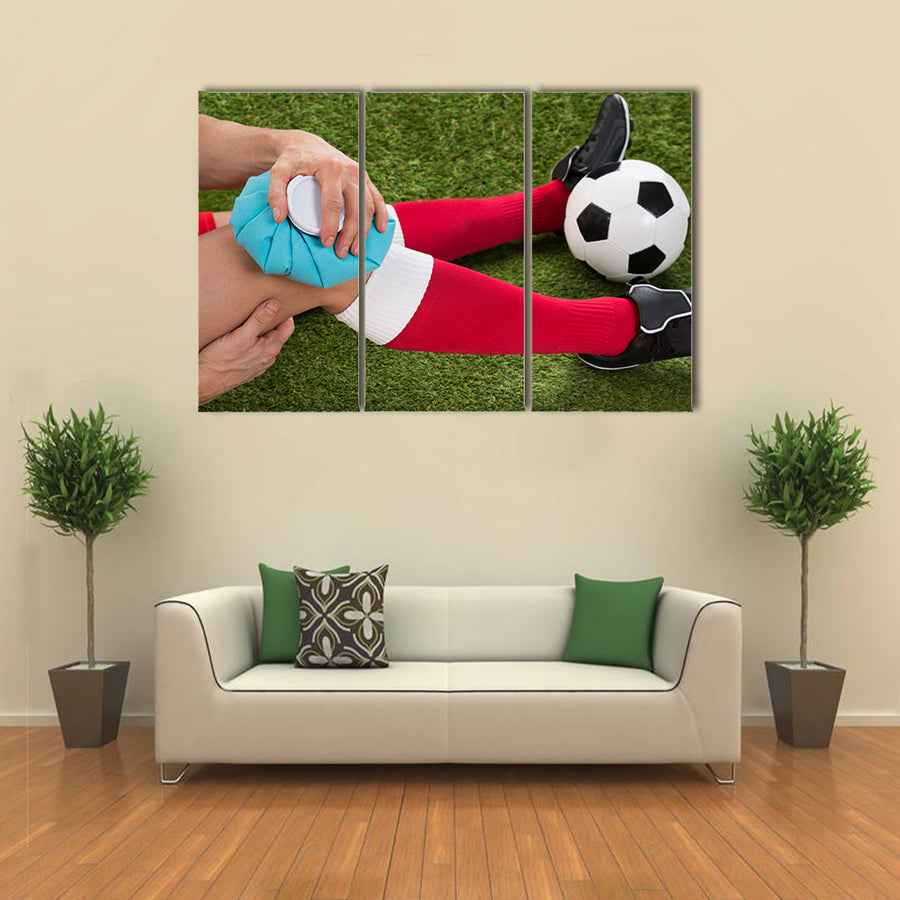 Close-up of a Soccer Player Icing Knee with Ice Pack on Field Multi panel canvas wall art