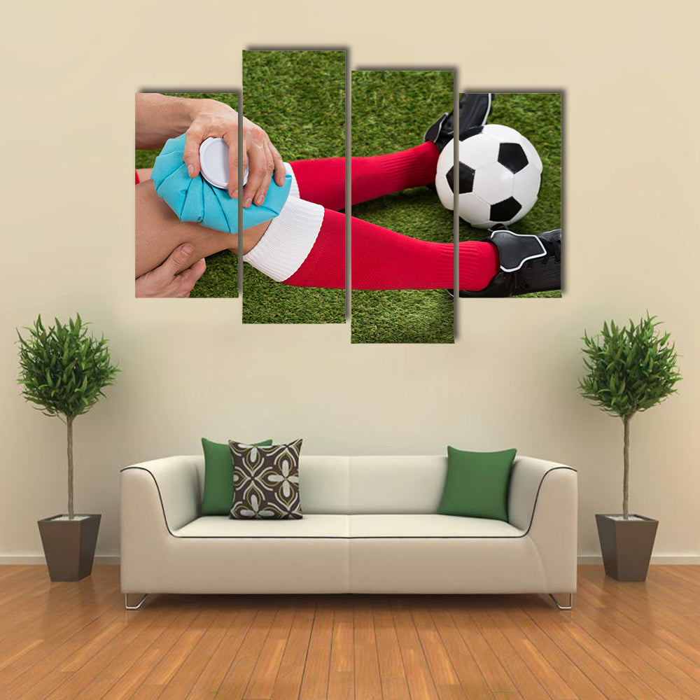Close-up of a Soccer Player Icing Knee with Ice Pack on Field Multi panel canvas wall art