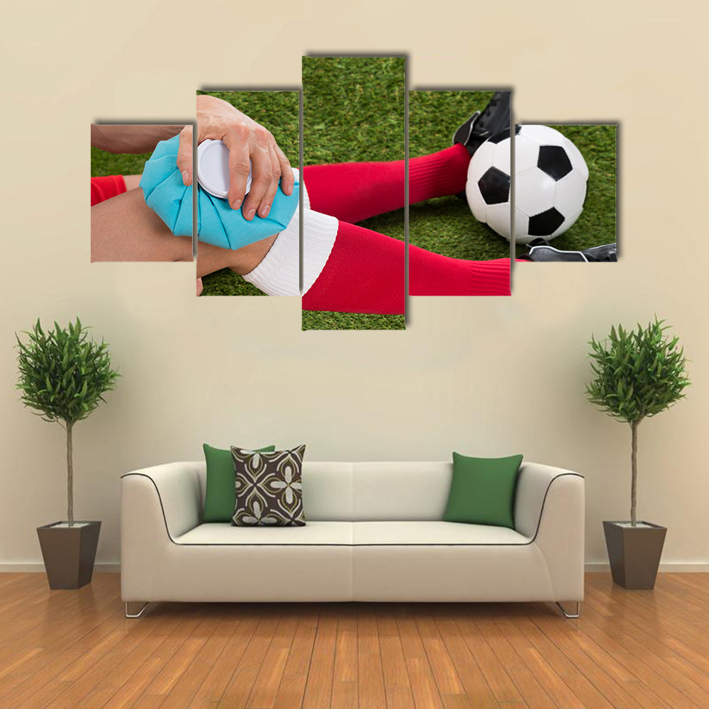 Close-up of a Soccer Player Icing Knee with Ice Pack on Field Multi panel canvas wall art