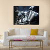 Motorbike with big exhaust pipe against a dark background Multi panel canvas wall art