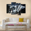 Motorbike with big exhaust pipe against a dark background Multi panel canvas wall art