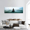 Woman practicing yoga on the beach panoramic canvas wall art