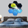 Tennis ball on a blue court  hexagonal canvas wall art