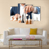 Closeup photo of businessman playing chess and beating black king multi panel canvas wall art