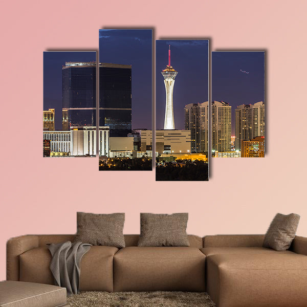 Stormy night sky behind the Stratosphere and Fontainebleau towers on the Las Vegas Strip Multi panel canvas wall art