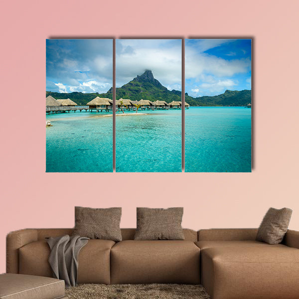 Luxury thatched roof over water bungalow resort in a vacation wall art