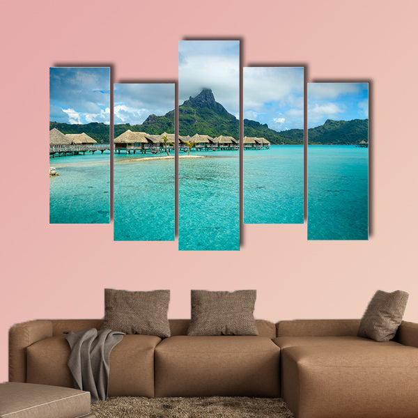 Luxury thatched roof over water bungalow resort in a vacation wall art