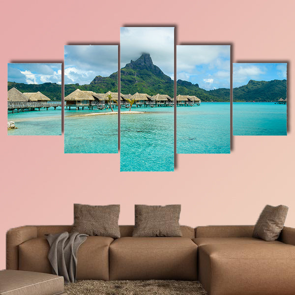 Luxury thatched roof over water bungalow resort in a vacation wall art