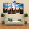 Beach volleyball silhouette at sunset Multi panel canvas wall art